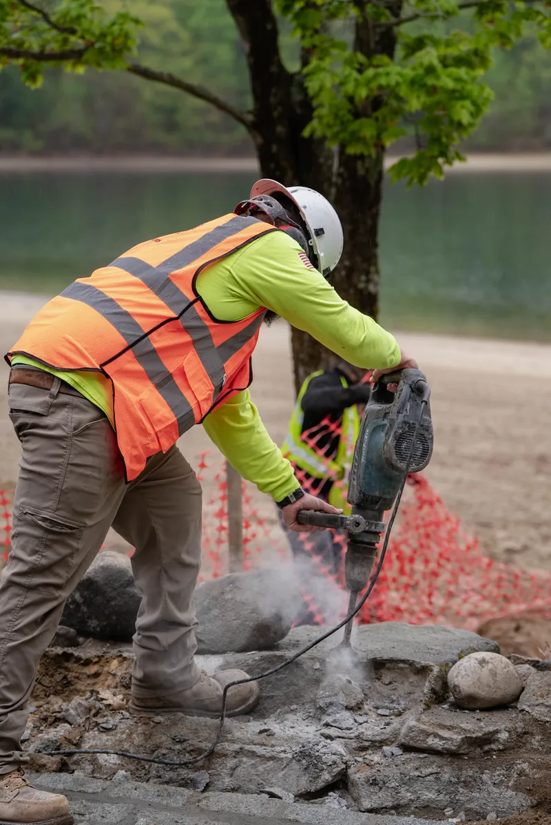 Empire mason shaping stone by hand at Walden Pond